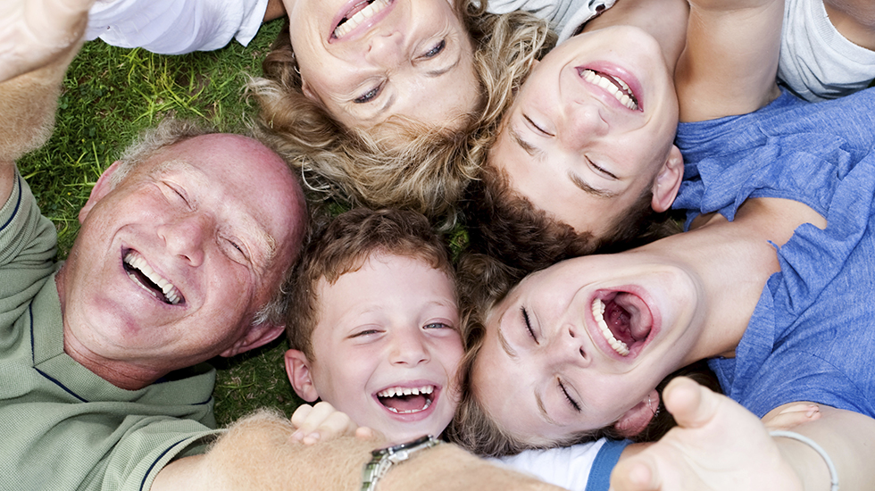 Multi-generation family lying in circle